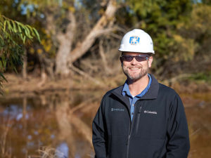 engineer standing next to pond