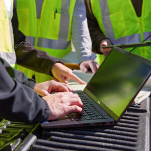 Engineers looking at GIS on laptop