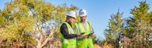 woman and man looking at field equipment