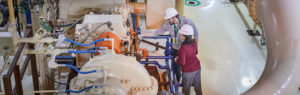 man and woman inspecting equipment
