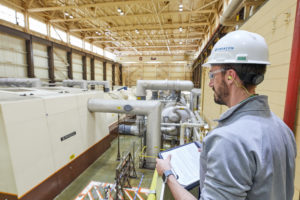 Person in hard hat looking at facility