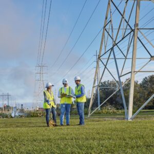 Electrical tower with three people in hard hats
